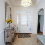 Entry way view of front door with custom shutters and custom side window shutters