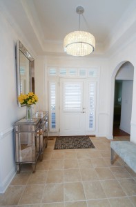 Entry way view of front door with custom shutters and custom side window shutters