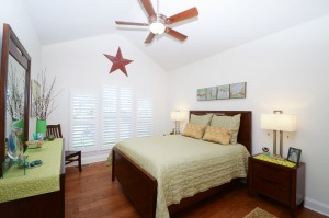 A bedroom with interior blinds from A Shade Above Millville DE